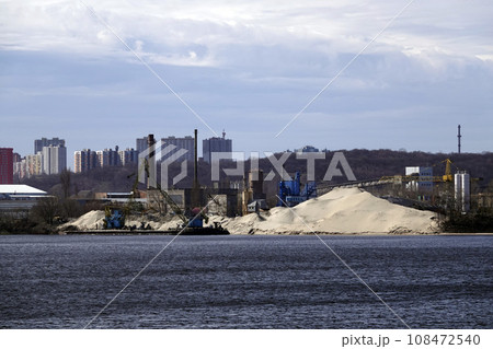 Kiev, Ukraine March 13, 2020: pier with an excavator for the embankment of sand on barges 108472540