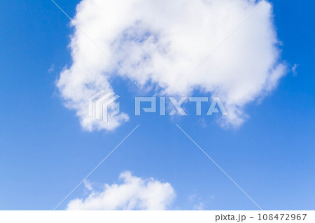 White airy beautiful clouds in a bright blue sky. Clear sunny weather. The concept of environmental safety and cleanliness. 108472967