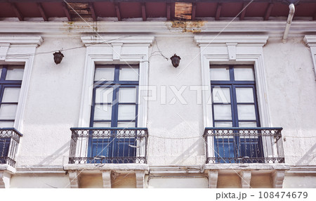 Street view of an old colonial building facade in Quito, color toning applied, Ecuador. 108474679