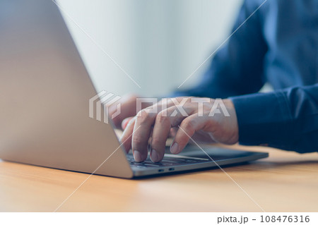 Man entrepreneur use laptop computer working at home. Male hands typing on the laptop keyboard. Business and technology concept of freelance work, work from home, businessman working at home office. Man entrepreneur use laptop computer working at home. Male hands typing on the laptop keyboard. Business and technology concept of freelance work, work from home, businessman working at home office. 108476316