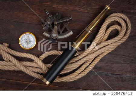 Retro vintage naval spyglass telescope with sextant and compass 108476412