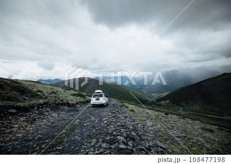 Off road car on top of high altitude mountain trail, China 108477198