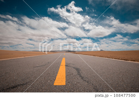 Trail in desert under blue sky 108477500