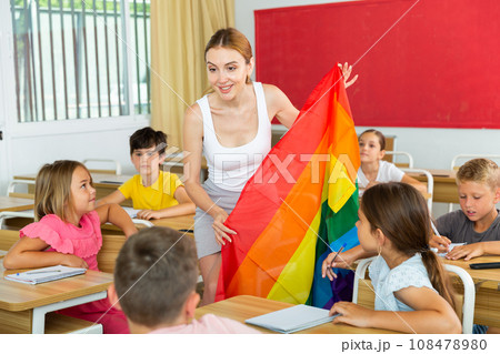 Positive female teacher standing with lgbt flag 108478980