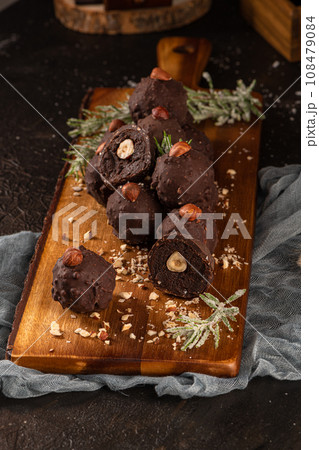 Dark chocolate truffles with hazelnuts 108479084