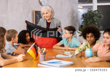 students listen to woman teacher who talks about Germany students listen to woman teacher who talks about Germany 108479163