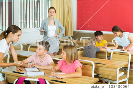 Preteen schoolchilds working in groups at lesson Preteen schoolchilds working in groups at lesson 108480064