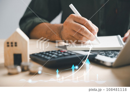 A person counts money using a calculator, manages budget with paper notes. Planning expenses including insurance, investment for residential property. Financial management concept. 108481118