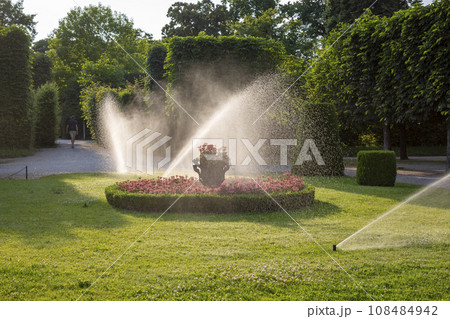 Watering lawns in the Schoenbrunn Palace Park 108484942