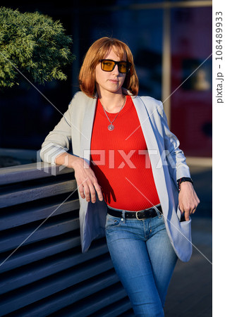 Close-up Portrait of Stylish Redhead Woman in Urban Autumn Fashion 108489933