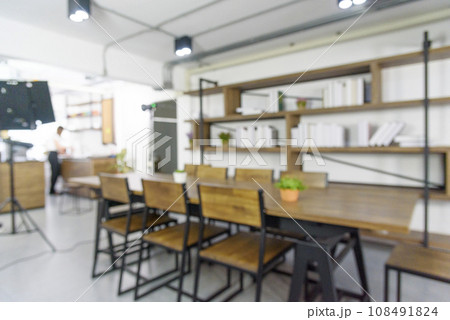 Blurred background cafe coffee shop restaurant in shopping mall with light bokeh business event retail store. Blurry background interior design bar table chair windows decorate indoor space display 108491824