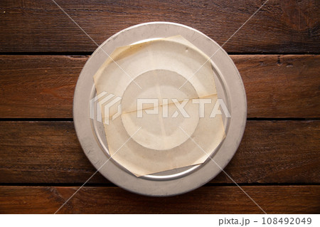Old cinema film reel box on a rustic wooden board Old cinema film reel box on a rustic wooden board 108492049
