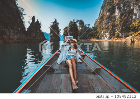 Traveler asian woman relax and travel on Thai longtail boat in Ratchaprapha Dam at Khao Sok National Park Surat Thani Thailand Traveler asian woman relax and travel on Thai longtail boat in Ratchaprapha Dam at Khao Sok National Park Surat Thani Thailand 108492312
