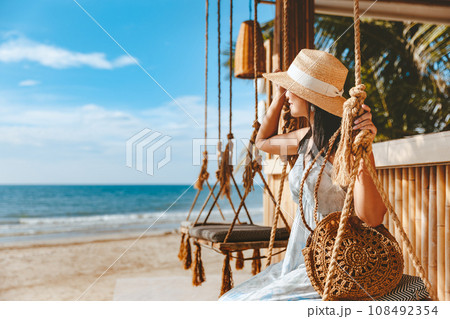 Traveler asian woman travel and relax on swing in beach cafe at Koh chang summer Thailand Traveler asian woman travel and relax on swing in beach cafe at Koh chang summer Thailand 108492354