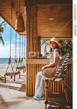 Traveler asian woman travel and relax on swing in beach cafe at Koh chang summer Thailand 108492355