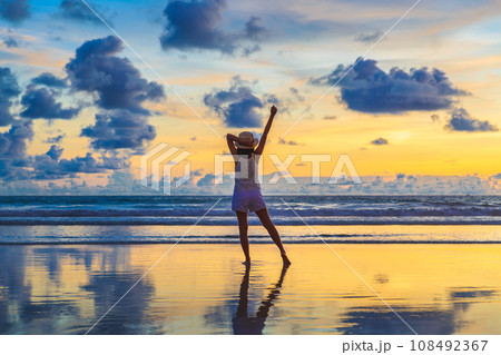 Traveler asian woman travel on Phuket beach in sunset Thailand 108492367