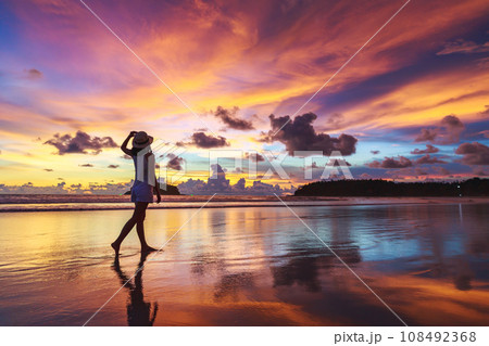 Traveler asian woman travel on Phuket beach in sunset Thailand Traveler asian woman travel on Phuket beach in sunset Thailand 108492368