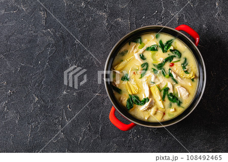 chicken spinach artichoke creamy soup in a pot 108492465