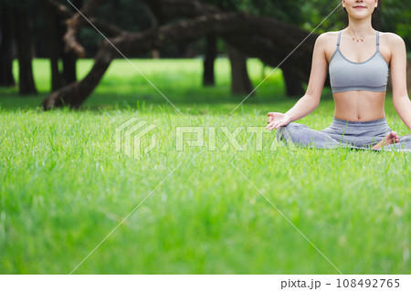 Fitness asian woman doing yoga in park 108492765