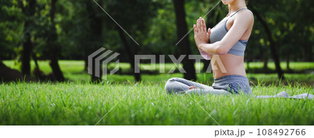 Fit asian woman doing yoga meditation in park fitness and heakthy outdoor concept Fit asian woman doing yoga meditation in park fitness and heakthy outdoor concept 108492766