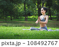 Fit asian woman doing yoga meditation in park fitness and heakthy outdoor concept 108492767