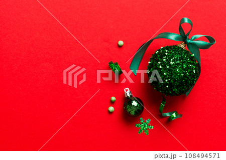Christmas ball on colored background. decoration bauble with ribbon bow with copy space Christmas ball on colored background. decoration bauble with ribbon bow with copy space 108494571