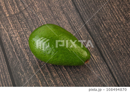 Ripe green avocado over background 108494870