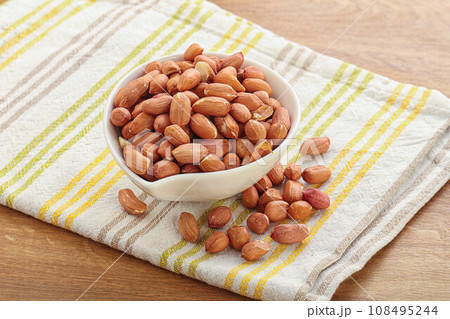 Raw peanut heap in the bowl Raw peanut heap in the bowl 108495244