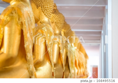 A Lot of Golden Statue of Buddha sitting meditated  in the row at Thailand Temple. 108495516