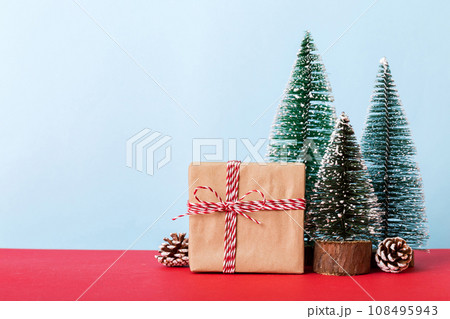 Christmas composition. Gifts, small tree, branches and craft DIY decorations on white background. New year concept. Christmas home decoration Flat lay, top view, copy space Christmas composition. Gifts, small tree, branches and craft DIY decorations on white background. New year concept. Christmas home decoration Flat lay, top view, copy space 108495943