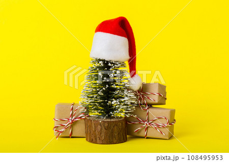 Christmas composition. Gifts, small tree, branches and craft DIY decorations on white background. New year concept. Christmas home decoration Flat lay, top view, copy space Christmas composition. Gifts, small tree, branches and craft DIY decorations on white background. New year concept. Christmas home decoration Flat lay, top view, copy space 108495953