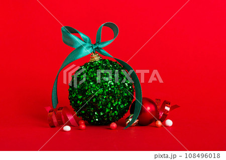 Christmas ball on colored background. decoration bauble with ribbon bow with copy space 108496018
