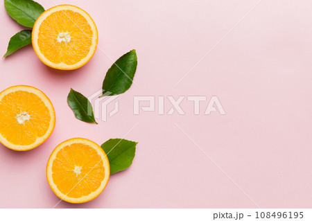 fresh Fruit orange slices on colored background. Top view. Copy Space. creative summer concept. Half of citrus in minimal flat lay with copy space fresh Fruit orange slices on colored background. Top view. Copy Space. creative summer concept. Half of citrus in minimal flat lay with copy space 108496195