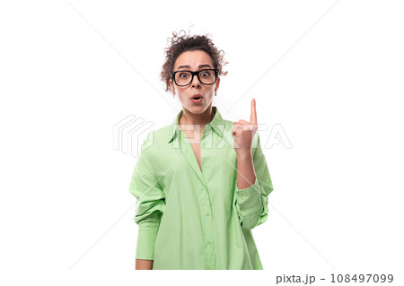 young stylish caucasian secretary woman with black curly hair in glasses and light green shirt on a 108497099
