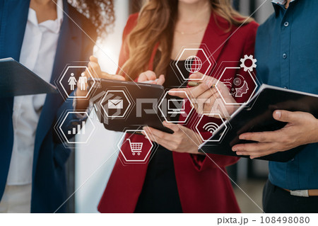 Businessmen team or financial data analysts working with tablets and laptop computers and data graphs together. Businessmen team or financial data analysts working with tablets and laptop computers and data graphs together. 108498080