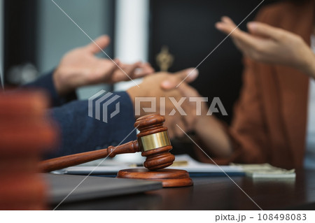 Lawyer shaking hands with client after discussing final contract agreement. Lawyer shaking hands with client after discussing final contract agreement. 108498083