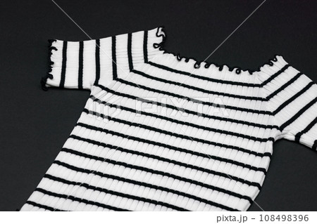 a frizzy knitwear tshit with horizontal black curve and curly line on clear background. 108498396