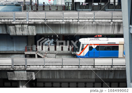 Bangkok Mass Transit System (BTS) in close up section view is driven across the Siam Square Station from Siam Square One Building view. Bangkok, Thailand. Bangkok Mass Transit System (BTS) in close up section view is driven across the Siam Square Station from Siam Square One Building view. Bangkok, Thailand. 108499002