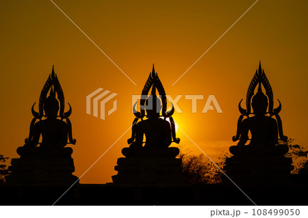 Silhouette Buddha statue between creating and building process, at outdoor field with the sun set and twilight period time., Thailand. Silhouette Buddha statue between creating and building process, at outdoor field with the sun set and twilight period time., Thailand. 108499050