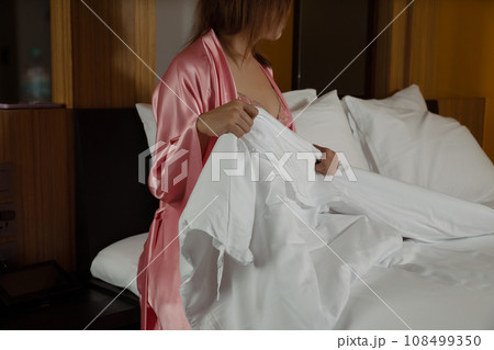 The Asian woman is going to bed at night. The Asian woman is going to bed at night. 108499350