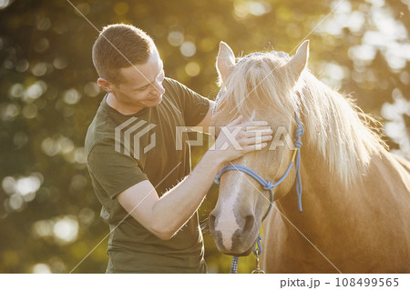 Man embracing of therapy horse. 108499565