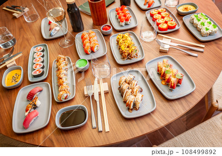 A set of sushi rolls on a table in a restaurant. 108499892