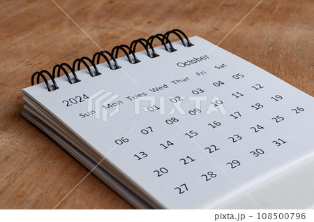 October 2024 white table calendar on wooden background. Calendar concept October 2024 white table calendar on wooden background. Calendar concept 108500796