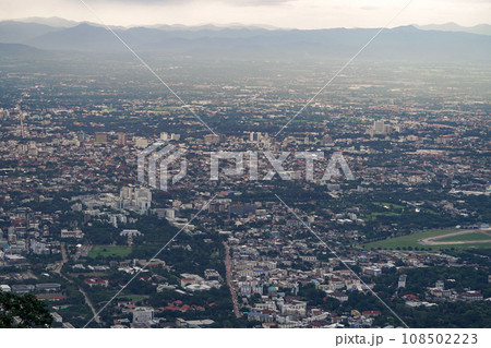 Top view of mountain in Chiang Mai City, Thailand. White cloud and dust is above of the mountain while cities can be seen far away. Top view of mountain in Chiang Mai City, Thailand. White cloud and dust is above of the mountain while cities can be seen far away. 108502223