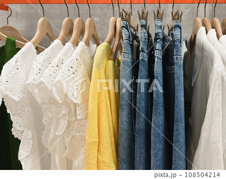 Blouses, sweaters, jeanshang on a hanger in the store Blouses, sweaters, jeanshang on a hanger in the store 108504214