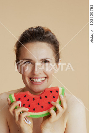 happy young 40 years old woman with watermelon shower sponge 108509763