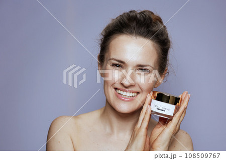 happy modern woman with cosmetic cream jar happy modern woman with cosmetic cream jar 108509767