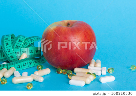 Weight Loss Pills and Measuring Tape, Diet Supplements Capsules, Obesity Lose Tablets, Color Drugs Pile 108510330
