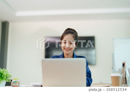 Young asian businesswoman manager, lawyer or company employee holding accounting bookkeeping documents checking financial data or marketing report working in office with laptop. Paperwork management. Young asian businesswoman manager, lawyer or company employee holding accounting bookkeeping documents checking financial data or marketing report working in office with laptop. Paperwork management. 108512534