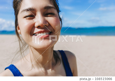 Close up face of happy woman in bright sunny beach in concept of skincare. 108515066